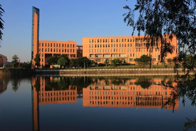 university, building, campus, lake, nature, architecture. Business schools curriculum: who sets each rule?